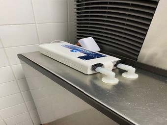 Icezone automated hygiene system installed on commercial ice machine